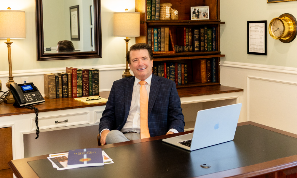 Stan Little seated at his desk