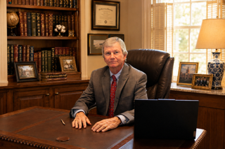 Jim Holland seated at his desk